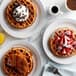 A plate of Carnival King Belgian waffles with strawberries and chocolate chips.