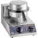 A stainless steel Carnival King Waffle Cone Maker on a counter in a professional kitchen with black and white knobs.