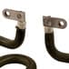 A close-up of two black metal heating elements with two hooks.