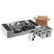 A Carnival King stainless steel cooking set with pans and utensils on a counter.