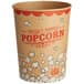 A brown and red Carnival King paper cup with popcorn on it.