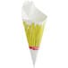 A white paper cone with yellow french fries in it.