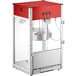 A red and white Carnival King commercial popcorn machine with a glass door.