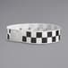 A black and white checkered Carnival King wristband.