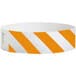 A white and neon orange striped Carnival King Tyvek wristband.