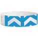 A white wristband with blue chevron arrows and rectangles.