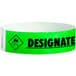 A green Carnival King paper wristband with black text that reads "DESIGNATED DRIVER"