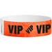 A red Tyvek wristband with black "VIP" text.