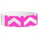 A pink and white Tyvek wristband with chevron arrows pointing up.