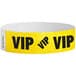 A yellow Carnival King wristband with black "VIP" text.