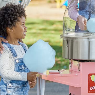 girl holding cotton candy in the park